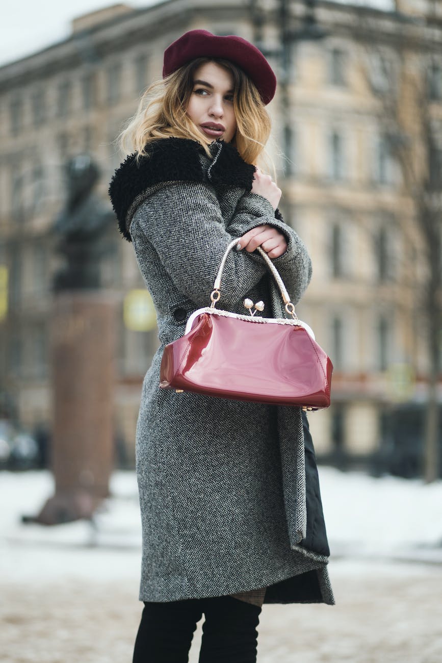 Winter Fashion - selective focus photography woman wearing gray coat standing near building